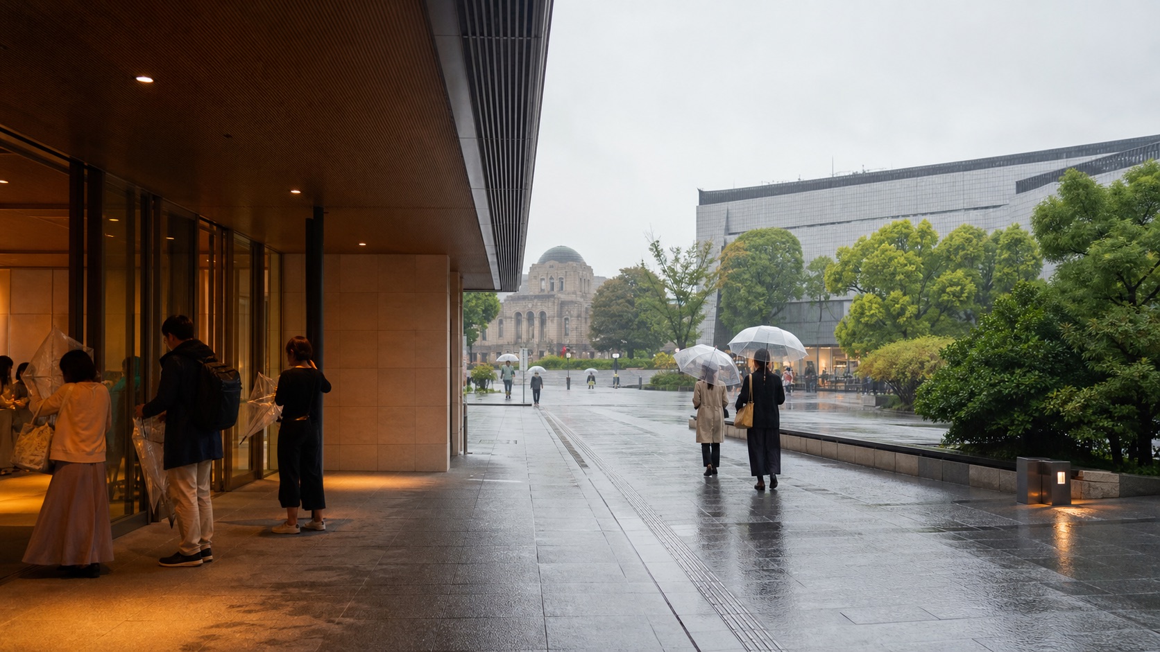 Visitors arriving with umbrellas at a Tokyo museum district on a rainy day